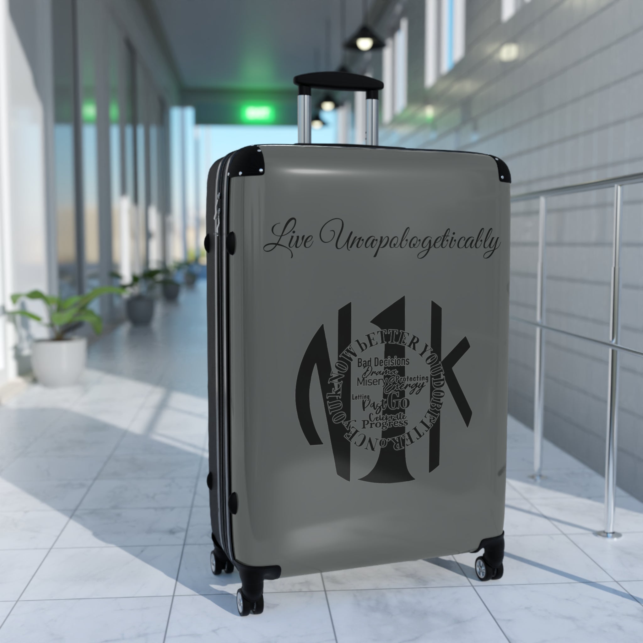 Live Unapologetically Suitcase in three sizes with hard-shell, 360° wheels, adjustable handle, and built-in lock